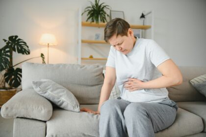 Sick upset middle aged lady hold belly suffer from abdomen ache concept